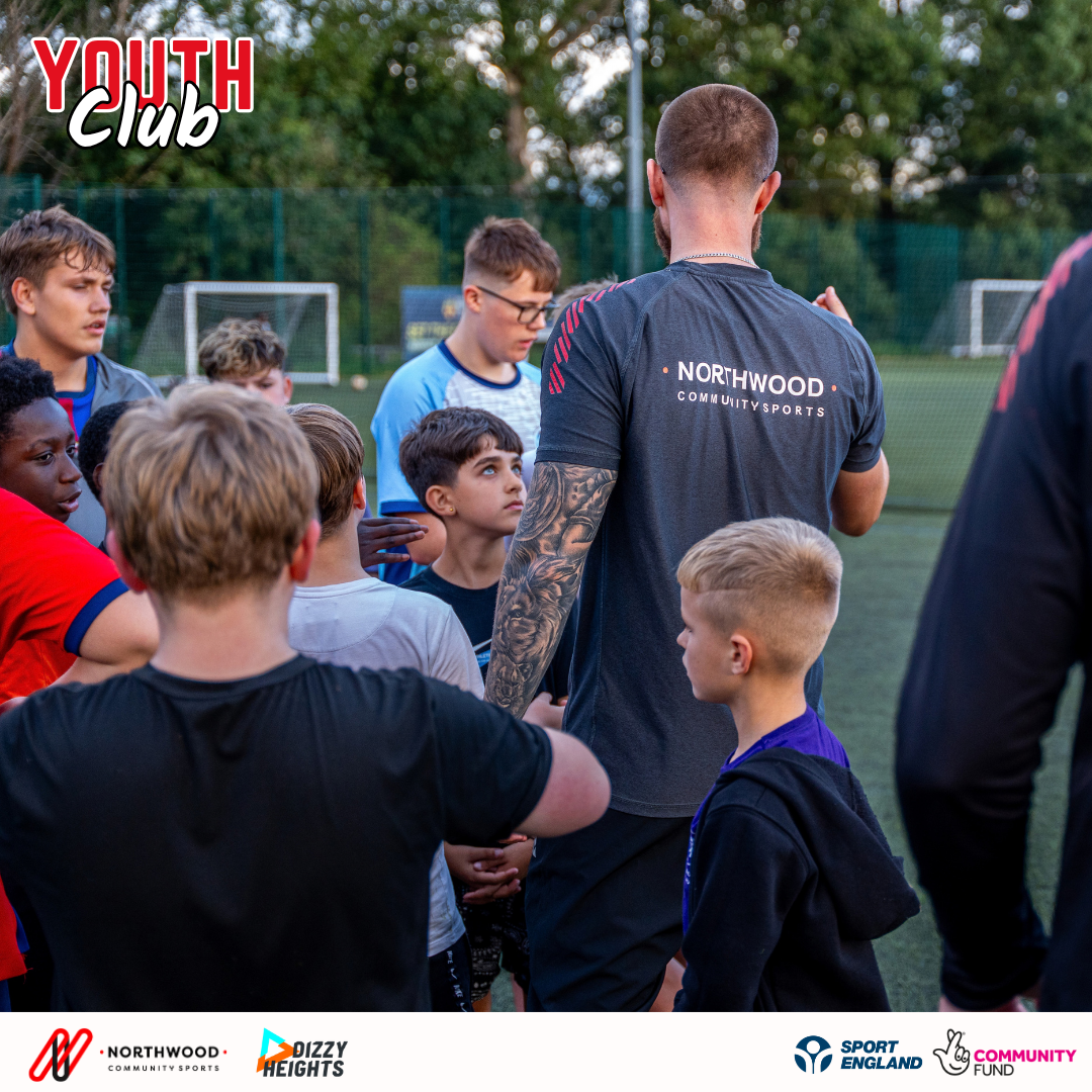 A Northwood staff member talking with a group of young people